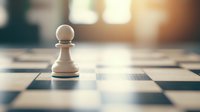 White chess pawn standing alone on chessboard with dramatic lighting and shallow depth of field, symbolizing strategy, leadership and first move in business game.