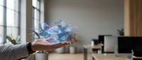 Hand holding holographic digital network connections with glowing nodes and data streams in modern office workspace for technology and connectivity concepts.