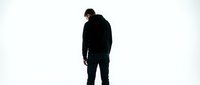 Silhouette of a man in dark casual clothing standing against white background, suitable for business, lifestyle, and editorial projects.