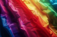 Vibrant diagonal rainbow stripes with silky fabric texture create dynamic abstract background perfect for pride themes, luxury design projects and modern presentations.