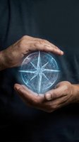 Male hands holding glowing compass rose hologram against dark background. Navigation, direction, guidance, and technology concept for business, travel, and digital innovation projects.