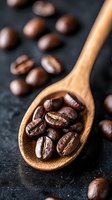 Fresh roasted coffee beans on wooden spoon against dark background, macro shot with selective focus showing rich brown color and natural texture.