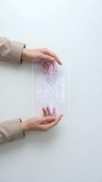 Two hands holding transparent glass panel with glowing network circuit diagram, representing digital technology, innovation, and future connectivity solutions for business presentations.