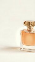 Elegant amber perfume bottle with golden cap on neutral background for luxury cosmetics and fragrance advertising campaigns.