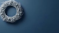 White wicker wreath on navy blue background with copy space for seasonal home decor and craft projects.