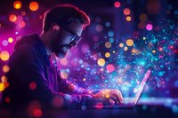 Young bearded man in glasses working on laptop at night with magical glowing light effects and bokeh creating atmospheric cyberpunk mood.