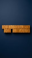 Purchase vs lease text formed with wooden blocks on dark blue background, representing business decision concept.