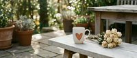 Cozy outdoor garden scene with coffee mug and roses on wooden bench surrounded by potted plants and warm sunlight filtering through foliage.