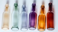 Colorful glass bottles arranged in rainbow sequence from beige to red on white background. Empty transparent containers create gradient effect in modern minimalist style.