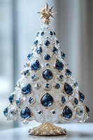 Elegant white ceramic Christmas tree decorated with sapphire blue crystals and silver glitter details, topped with golden star ornament on decorative base.