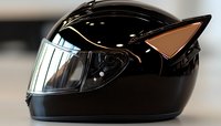 Black motorcycle helmet with cat ears design features glossy finish and clear visor, combining safety with playful style for modern riders and cosplay enthusiasts.