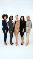 Five diverse businesswomen standing together in professional attire against white background. Includes African American, Caucasian, and Middle Eastern women wearing blazers and business wear for corporate team concepts.
