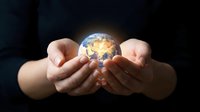 Hands holding glowing Earth globe against dark background, symbolizing global responsibility, environmental care, and sustainable business practices for corporate messaging.