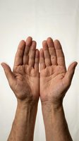 Open male hands with palms facing up in receiving gesture against neutral background for spiritual and wellness concepts.
