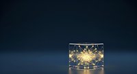 Glowing light bulb inside transparent glass cube on dark blue background, symbolizing innovation, creativity, and bright ideas for business concepts.
