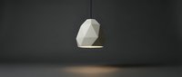 Geometric white pendant lamp with faceted polygonal design hanging in dark interior space, casting warm light for modern home decor.
