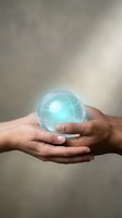 Hands of a male with medium skin tone holding a glowing turquoise globe with illuminated grid lines, symbolizing global connectivity, technology, and environmental care for business and sustainability concepts.