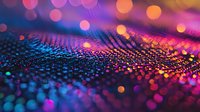 Vibrant glitter texture with colorful bokeh lights in pink, purple, orange and blue creating dreamy abstract background with sparkle and shine effect.