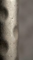 Close-up detail of weathered concrete column surface showing natural aging texture with scratches and imperfections for architectural design projects.