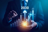 Businessman holding glowing holographic growth chart with 2030 projection and upward trending arrows showing future business success and financial planning.