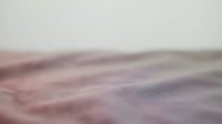 Soft blurred sand dunes with gentle pink and purple tones, creating an abstract, dreamy landscape suitable for backgrounds and design projects.