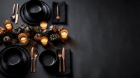 Elegant black and copper table setting with pinecones and candles on dark background for autumn dinner party or holiday celebration.