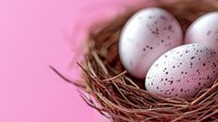 White speckled eggs nestled in natural twigs nest against pink background, selective focus creates soft dreamy mood for spring and Easter designs.