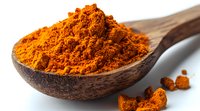 Ground turmeric powder in wooden spoon on white background, bright orange aromatic spice with scattered pieces, macro food photography for cooking and health.