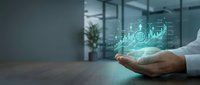 Business professional displaying holographic financial data analytics with glowing charts and graphs in modern office environment for investment presentations.