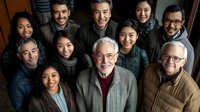 Diverse multigenerational business team smiling together in office, showing workplace diversity and inclusion. Professional corporate group portrait represents unity.