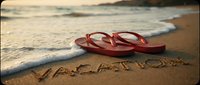 Red flip flops resting on sandy beach with vacation written in sand, gentle ocean waves in background, summer holiday travel concept.
