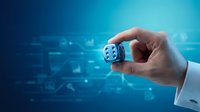 Hand holding white dice with blue digital interface background, representing risk management, decision making, and business strategy for corporate presentations.