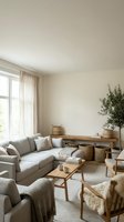 Scandinavian living room with neutral tones, gray upholstered sofa, wooden furniture, potted plants, natural light from large windows, and minimalist decor for home interior design projects.