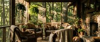 Cozy sunlit screened porch with wicker furniture and lush plants creating peaceful indoor-outdoor living space for relaxation and entertaining.