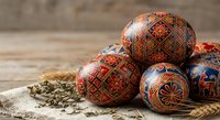 Traditional Ukrainian Easter eggs with intricate folk patterns on rustic wooden background, perfect for holiday celebrations and cultural designs.