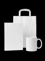 Blank white merchandise set including tote bag, book, and mug isolated on transparent background. Ready for custom design, sublimation, print-on-demand products, and branding projects.