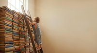Young girl climbing wooden ladder to reach books in towering library stack, pursuing knowledge and education goals with determination and curiosity.