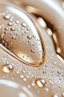 Macro shot of water droplets on metallic gold surface creating abstract pattern with light reflections and bokeh effect. Luxury and elegance concept for design use.