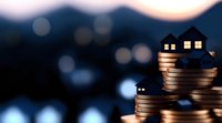 Small house model placed on stacked coins against blurred bokeh background, representing real estate investment, property market and mortgage concept.