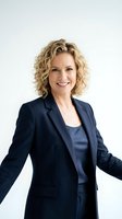 Confident middle-aged Caucasian businesswoman with curly blonde hair in navy blue suit smiling professionally against white background for corporate use.