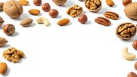 Mixed nuts collection with walnuts almonds hazelnuts pecans cashews on white background for healthy snacking and cooking recipes.