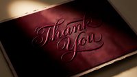 Thank you you card with embossed script lettering on burgundy velvet material with gold foil edge, suitable for gratitude and appreciation designs.