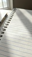 Open spiral notebook with lined pages and wooden pencil on desk near window with natural sunlight for writing and note-taking.