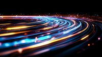 Curved light trails in blue and orange colors create dynamic motion effect against dark background, abstract long exposure photography showing speed and technology.
