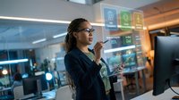 African American businesswoman with dreadlocks using holographic interface technology in modern office environment for digital transformation and innovation.