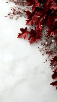 Deep red maple leaves and delicate berries create elegant corner border on white background, offering natural decorative frame for seasonal designs.