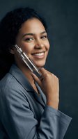 Happy mixed race businesswoman holding smartphone making phone call in professional office setting for corporate communication and business success.