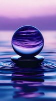 Crystal sphere floating above rippling water surface with purple and blue reflections creating mesmerizing symmetrical patterns in mystical atmosphere.