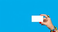 Hand holding blank white card against bright blue background, ideal for business cards, promotional materials, and advertising campaigns.
