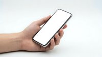 Hand holding modern smartphone with blank white screen mockup for app presentation and mobile interface design projects.